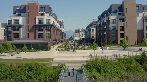 A modern residential area with apartment buildings and a pedestrian walkway.