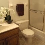 a bathroom with a toilet and a sink and a shower