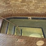 the bottom of a glass floor in a swimming pool