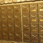a row of mail boxes with birds on them