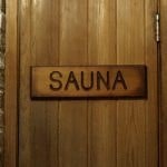 a wooden door with a sign that reads sauna