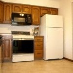 a kitchen with a stove refrigerator and microwave