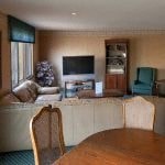 a living room with a dining table and a television