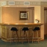 a bar with three stools in front of it