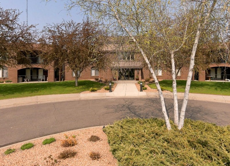 a large brick building with trees in front of it
