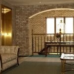 a living room with a couch and a piano