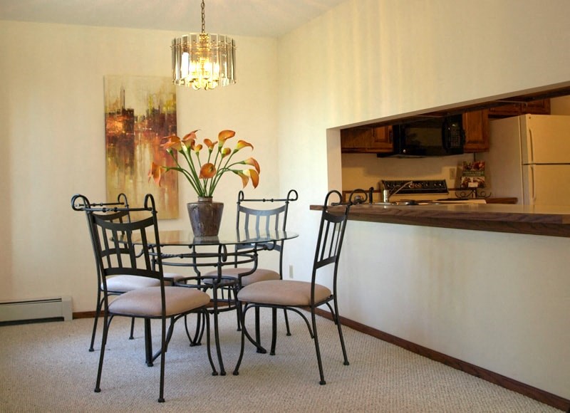a dining room with a table and chairs