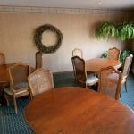 a dining room with a wooden table and chairs