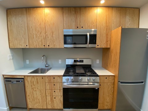 A kitchen with wooden cabinets and stainless steel appliances.