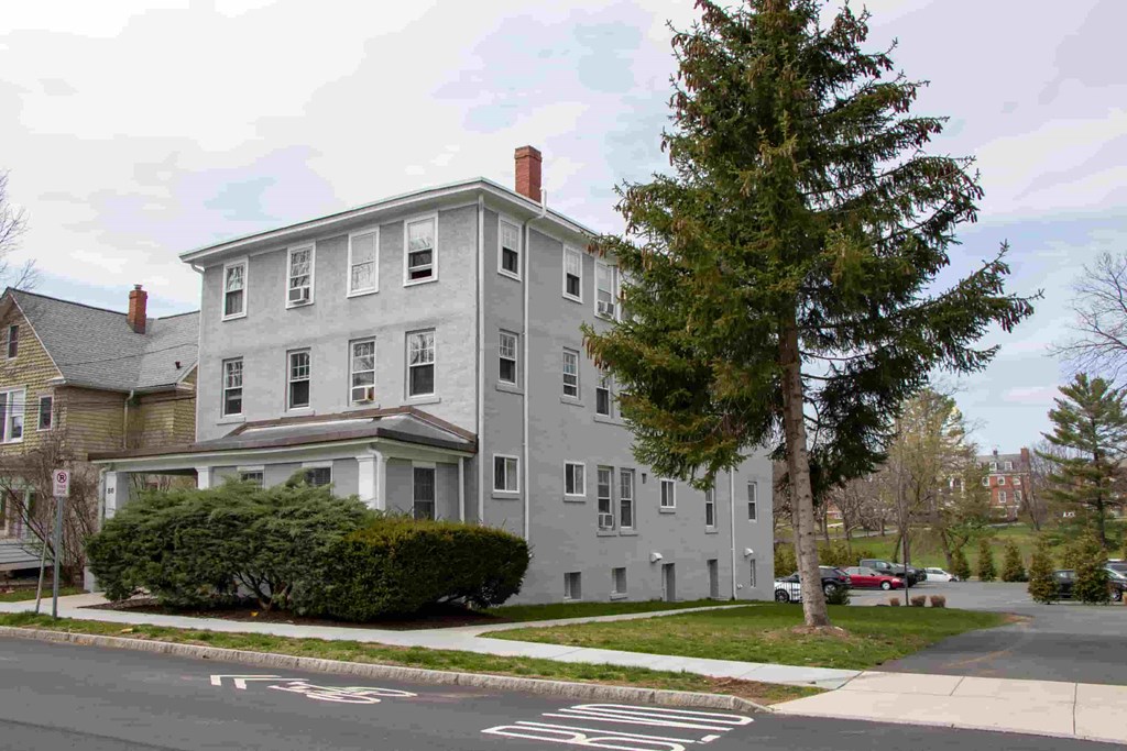 a gray building on the corner of a street
