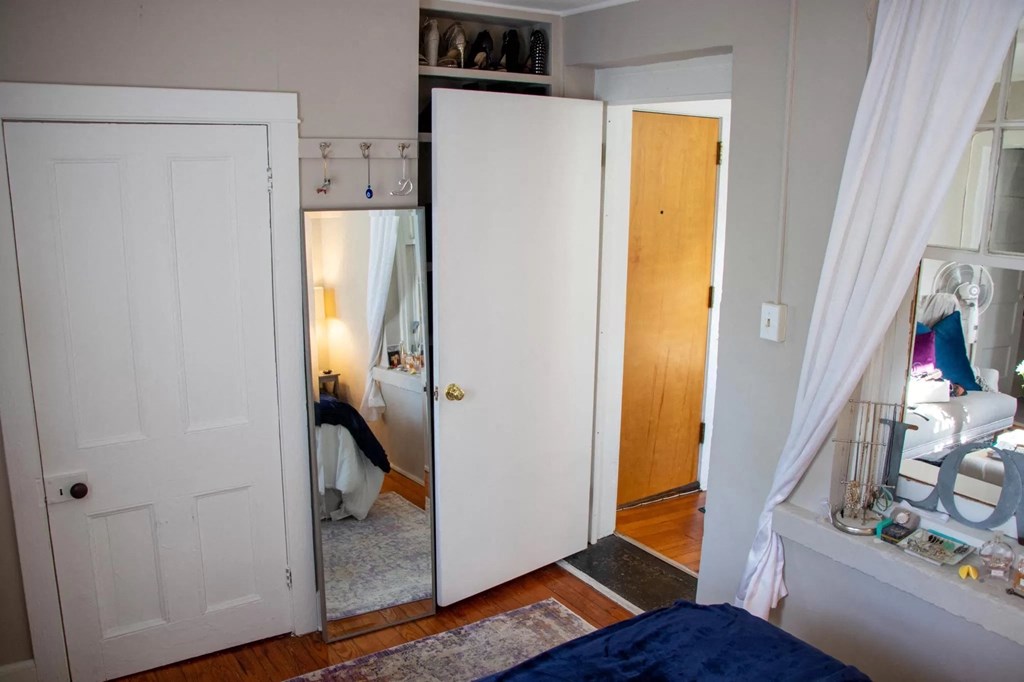 a bedroom with a closet and a bed and a mirror