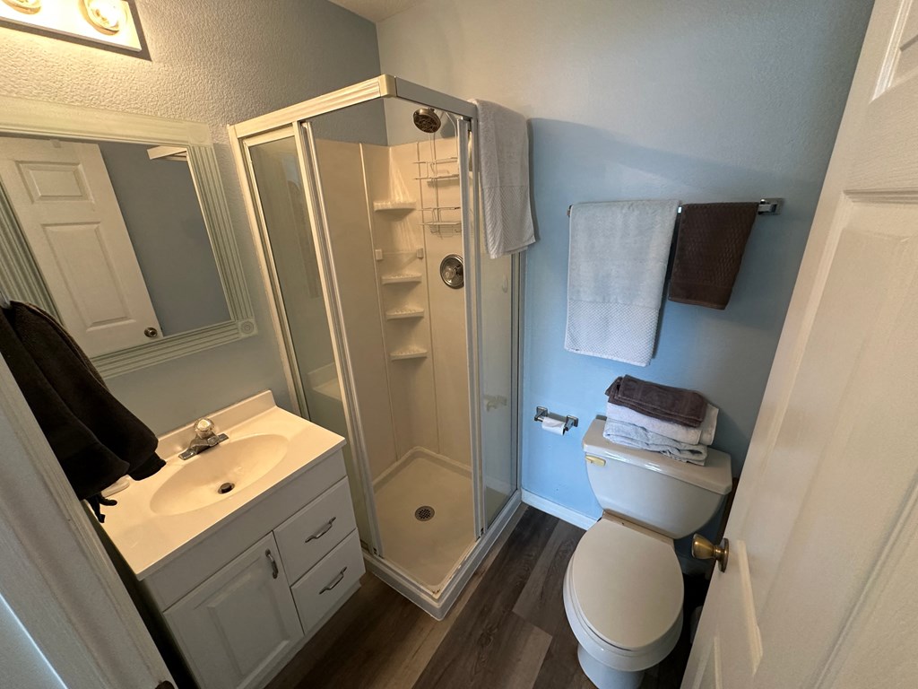 a small bathroom with a shower toilet and sink