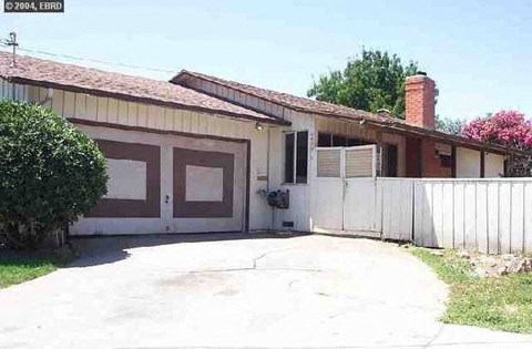a house with a white fence and a garage door