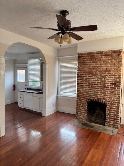 A room with a fireplace and a ceiling fan.