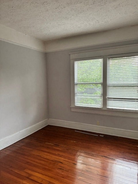 A room with a window and wooden floors.