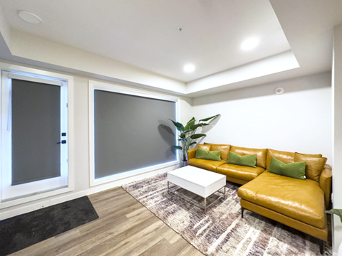 a living room with a yellow couch and a coffee table