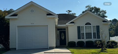 a white house with a white garage door