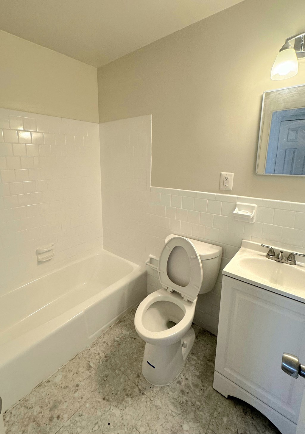 a bathroom with a toilet and a tub and a sink