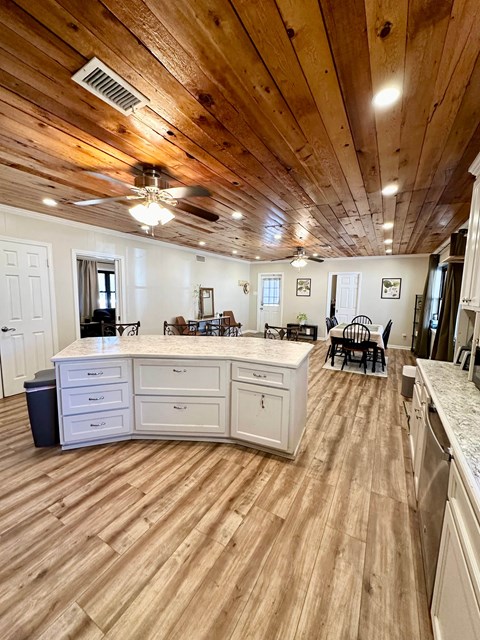 a kitchen with a center island and a dining room