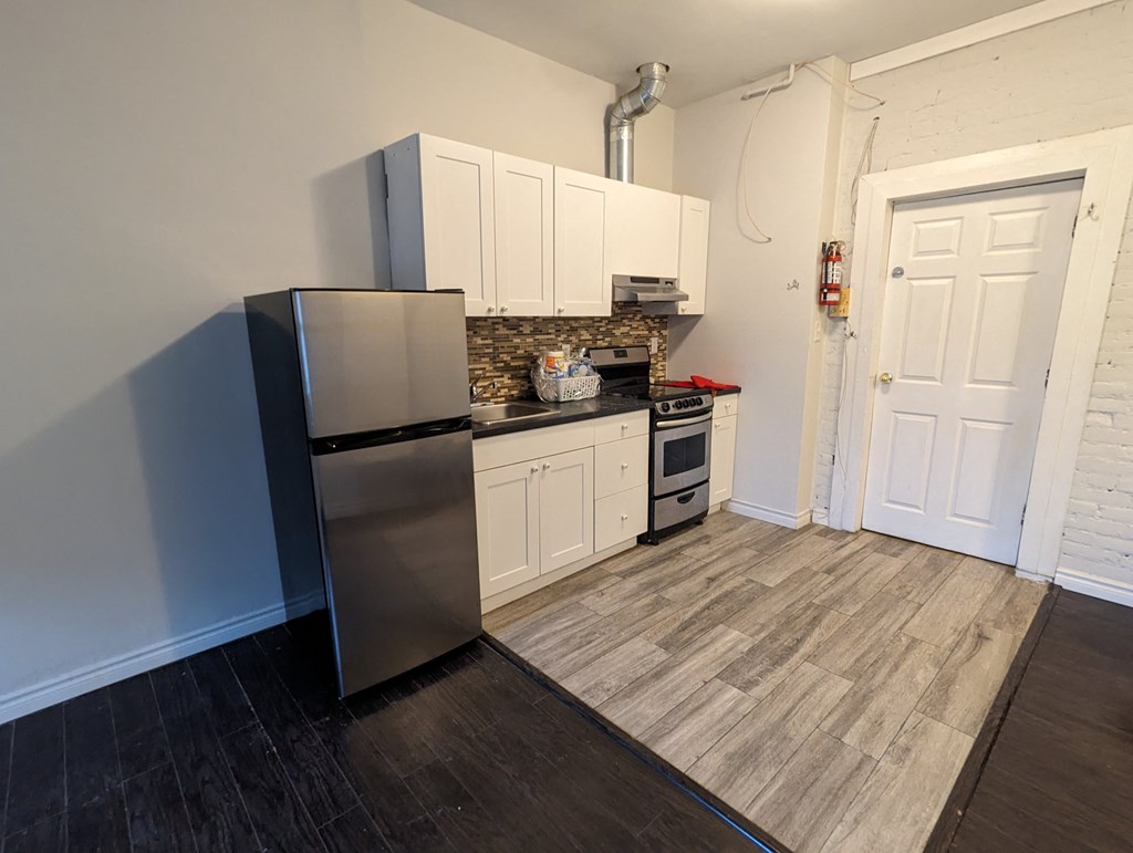 a kitchen with stainless steel appliances and white cabinets