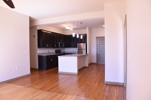 A kitchen with black cabinets and white countertops.
