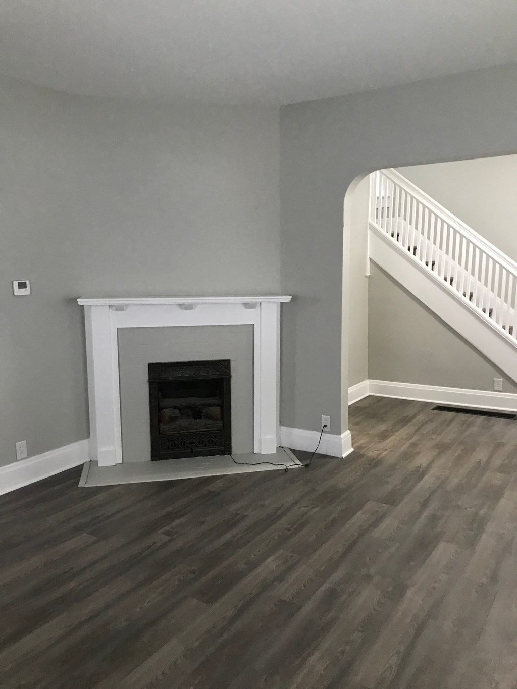 the living room has a fireplace and hardwood floors