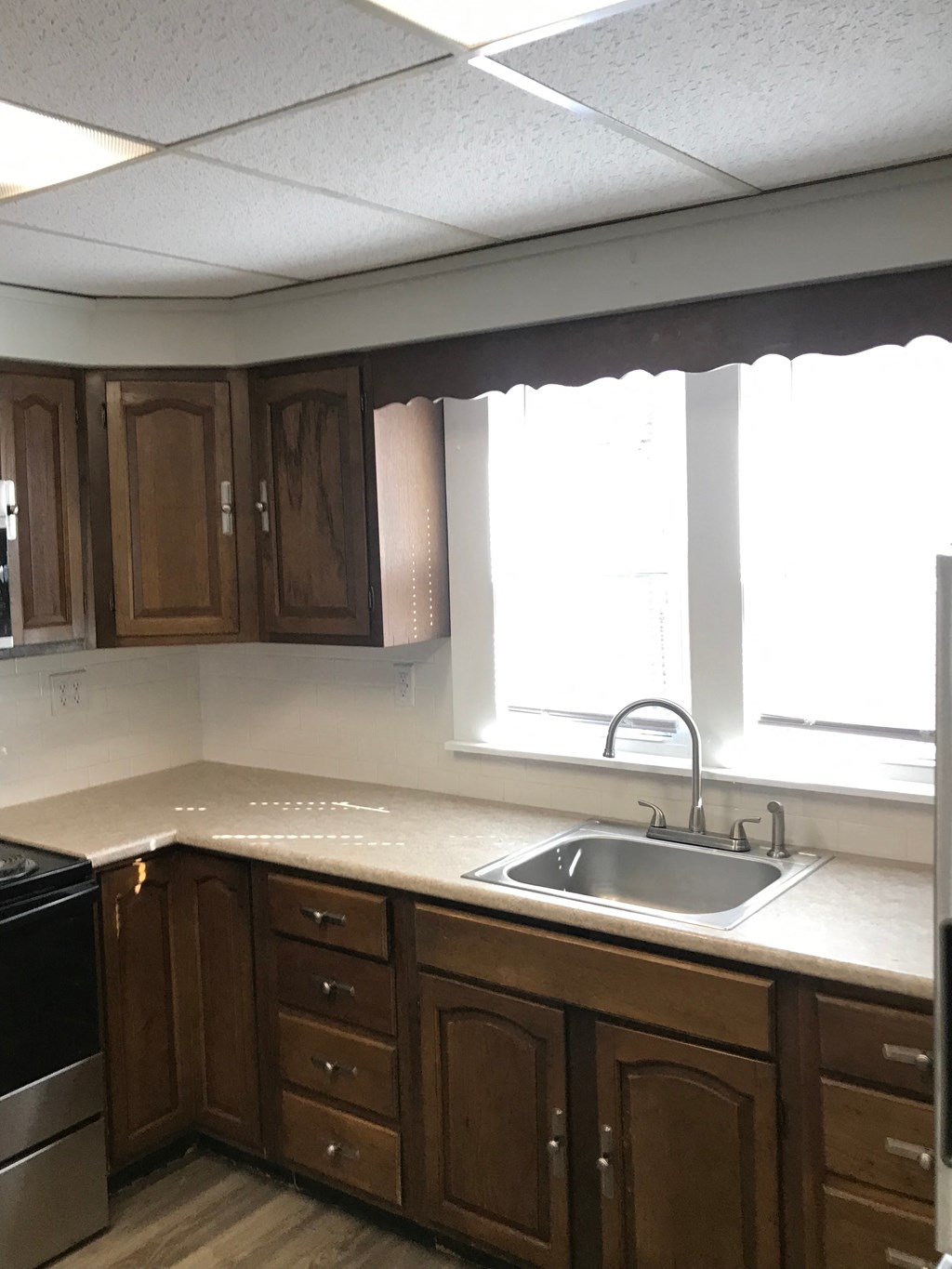 an empty kitchen with a sink and a window