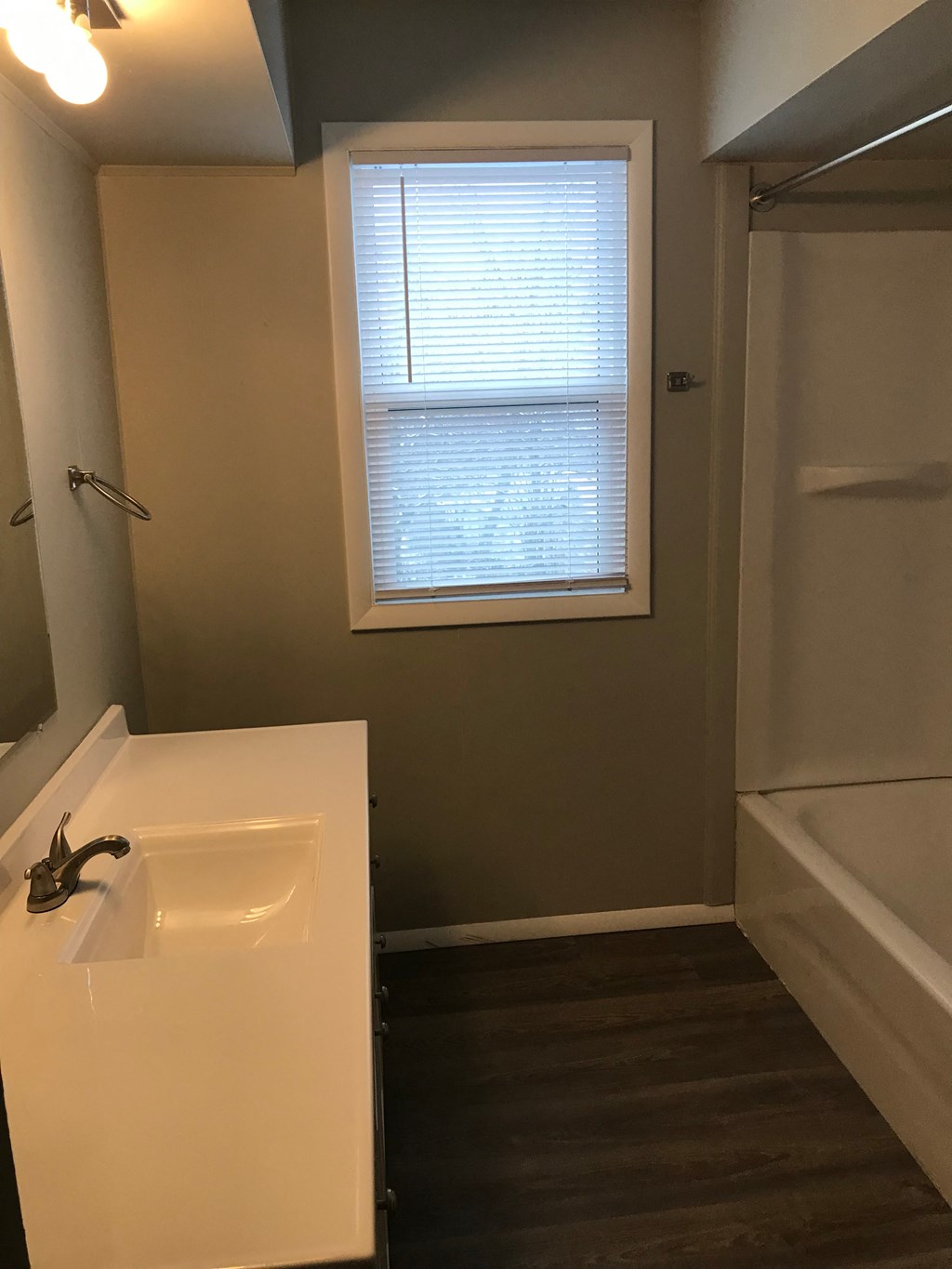 a small bathroom with a sink and a window