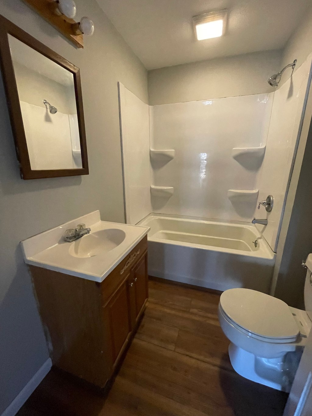 a small bathroom with a sink toilet and shower