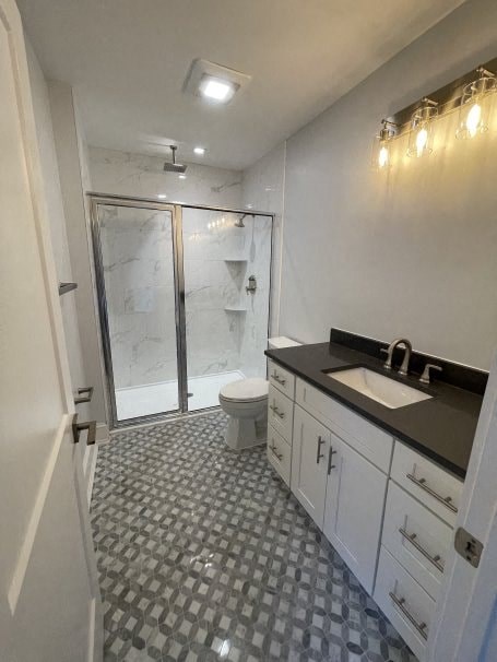a bathroom with a toilet and a sink and a shower