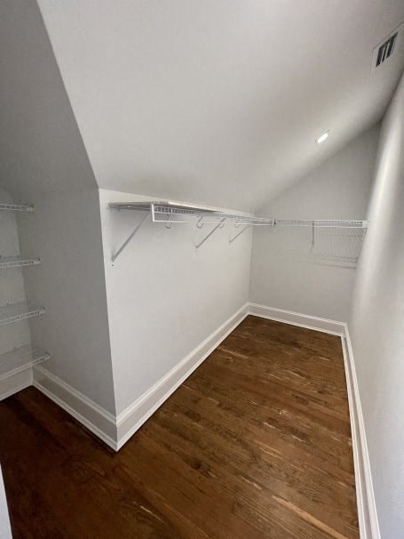 a empty room with white shelves and a wood floor