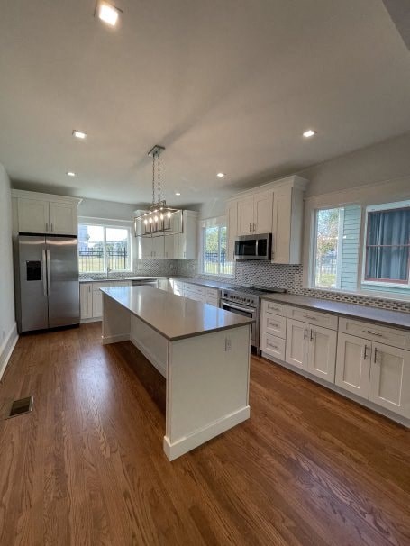 a large kitchen with an island in the middle