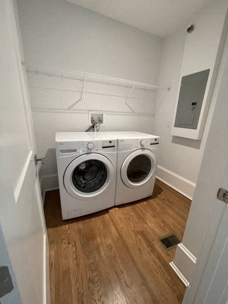 a washer and dryer in a room with a wooden floor