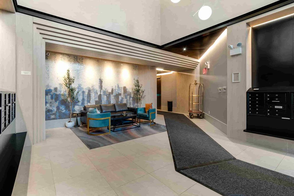 the lobby of the building is spacious and has a large screen tv