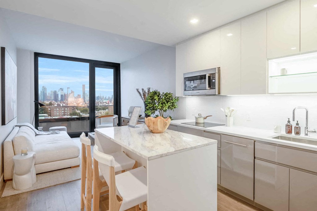 an open kitchen and living room with a table and chairs