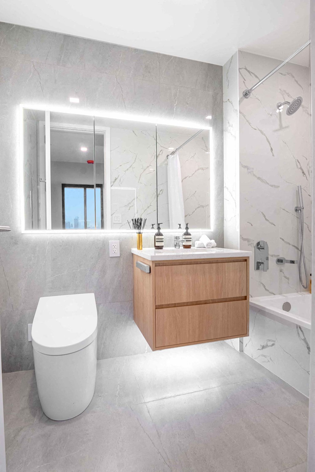 a bathroom with a toilet and a vanity with a mirror