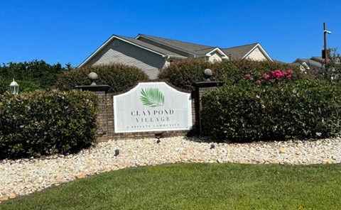 a house with a sign in front of a lawn