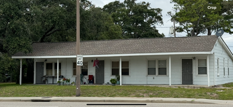 a white house with a street sign in front of it