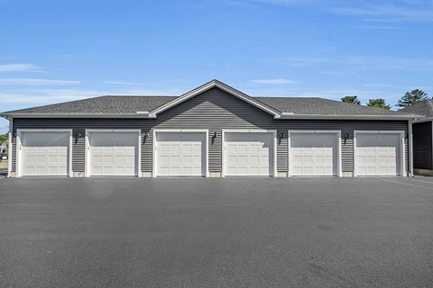 a row of three garage doors on the side of a building