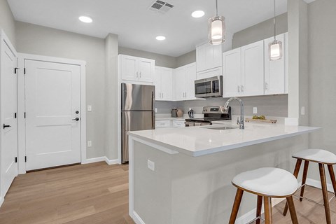 a kitchen with white cabinets and a counter top