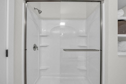 a shower with a glass door in a bathroom