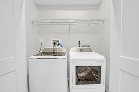 a small laundry room with two washes and a dryer