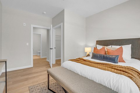 a bedroom with a large bed and a couch