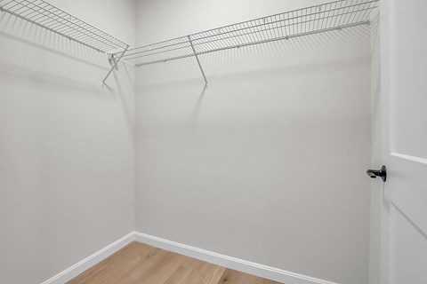 an empty closet with a wire rack on the wall