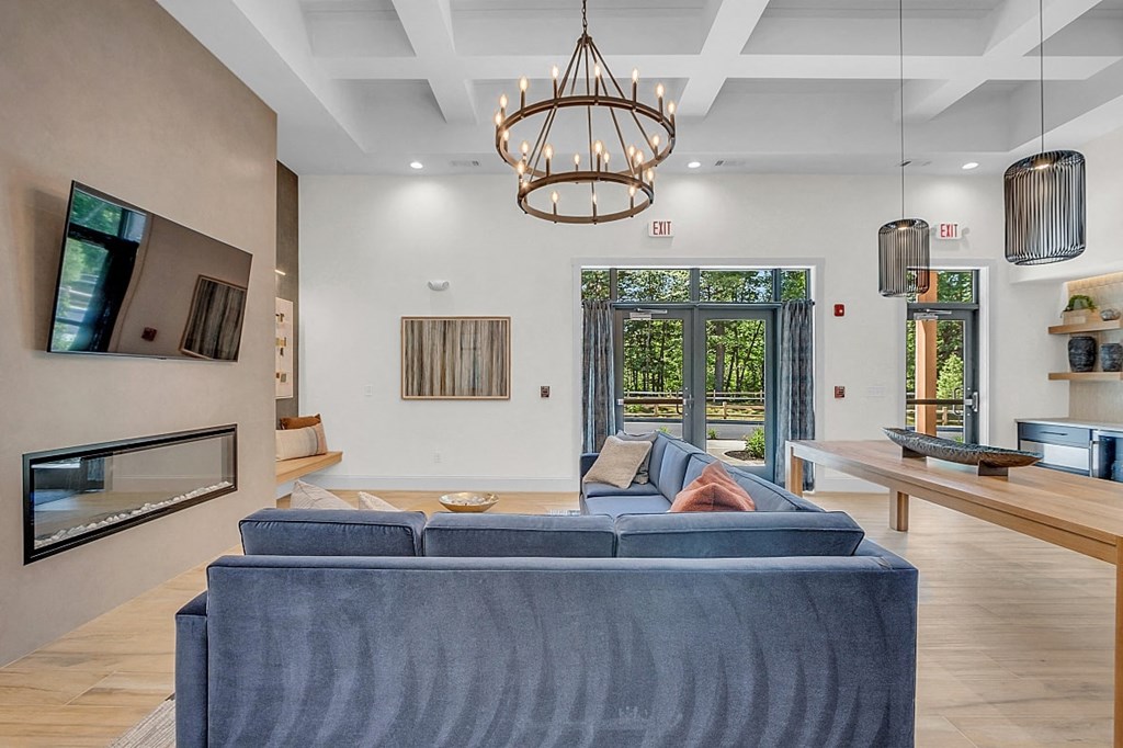 a living room with a blue couch and a fireplace