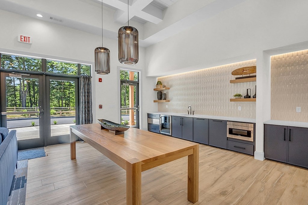 a kitchen with a wooden table and blue cabinets