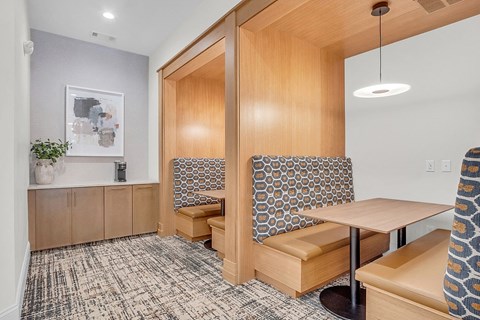 a seating area in a room with a table and chairs