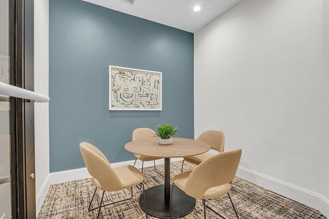 a conference room with a round table and chairs
