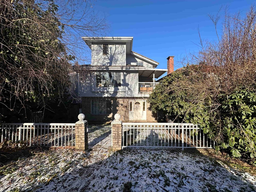 a white house with a white fence in front of it