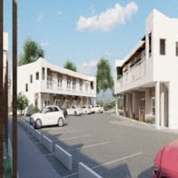 an image of a parking lot with cars in front of buildings